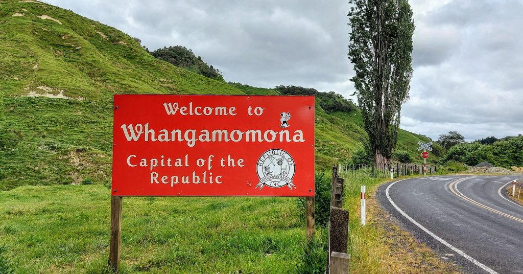 Red sign of Whangamomona Welcome Sign along Forgotten World Highway North Island New Zealand