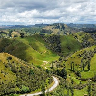 Landscape of green rolling hills and saddles along the Forgotten World Highway in North Island of New Zealand